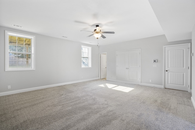 carpeted empty room with ceiling fan