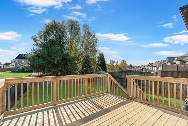 wooden terrace featuring a lawn