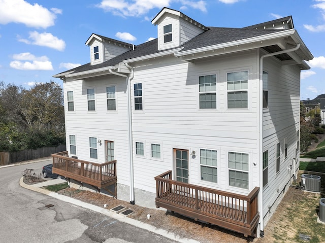 back of house featuring a deck and cooling unit