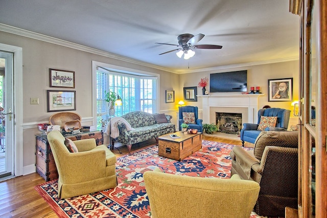 living room featuring crown molding, hardwood / wood-style flooring, and ceiling fan