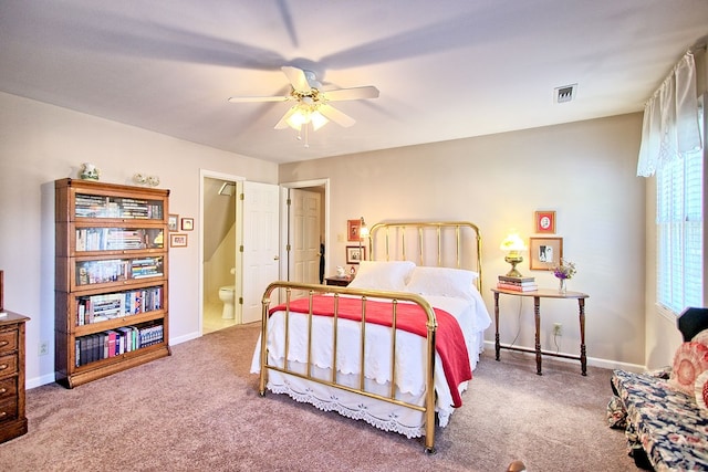 bedroom featuring carpet flooring, ensuite bathroom, and ceiling fan