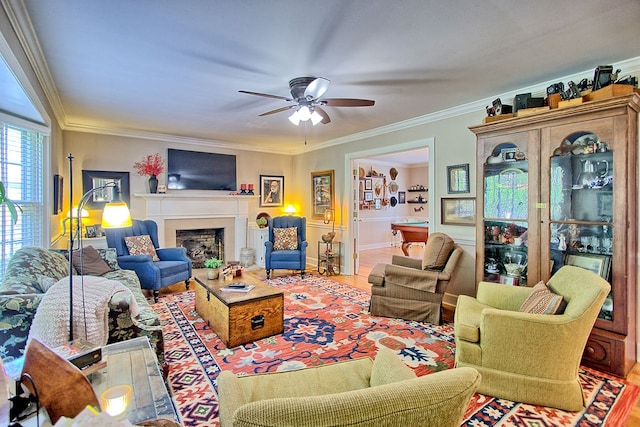 living room with ceiling fan, ornamental molding, and wood-type flooring