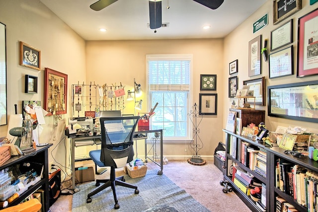 carpeted office space with ceiling fan