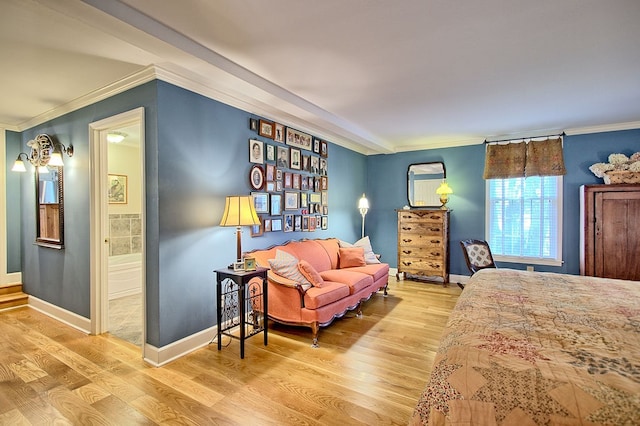 bedroom featuring ornamental molding, wood-type flooring, and ensuite bath