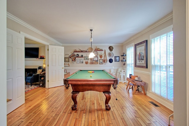 recreation room featuring pool table, ornamental molding, and light wood-type flooring