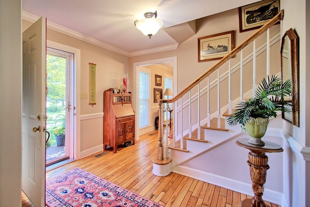 entrance foyer with crown molding and light wood-type flooring