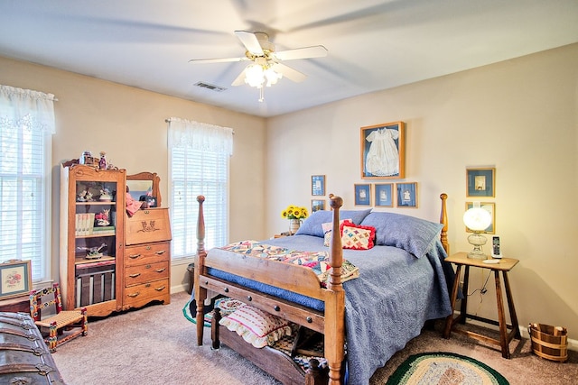 bedroom with ceiling fan and light carpet