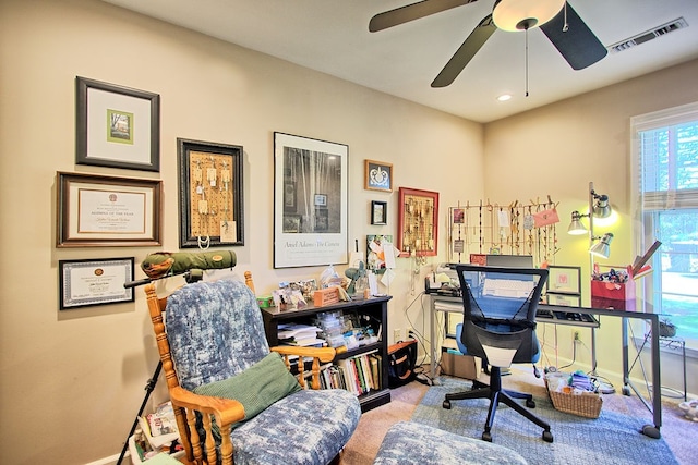 office area featuring light carpet and ceiling fan