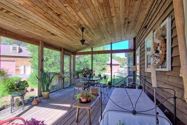 unfurnished sunroom featuring ceiling fan, wooden ceiling, and vaulted ceiling