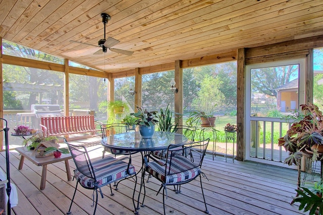 unfurnished sunroom with wood ceiling, ceiling fan, and vaulted ceiling