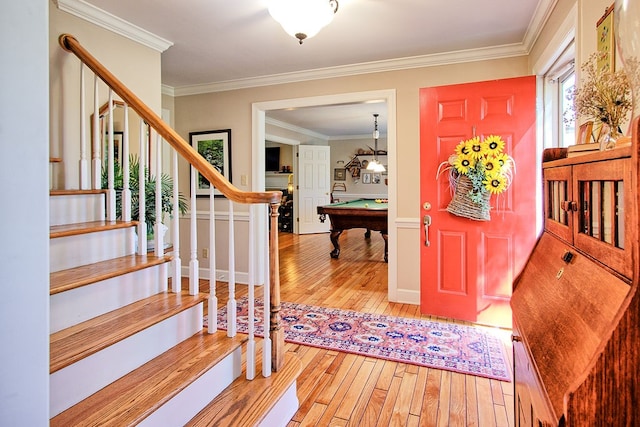 entrance foyer featuring ornamental molding, billiards, and wood-type flooring