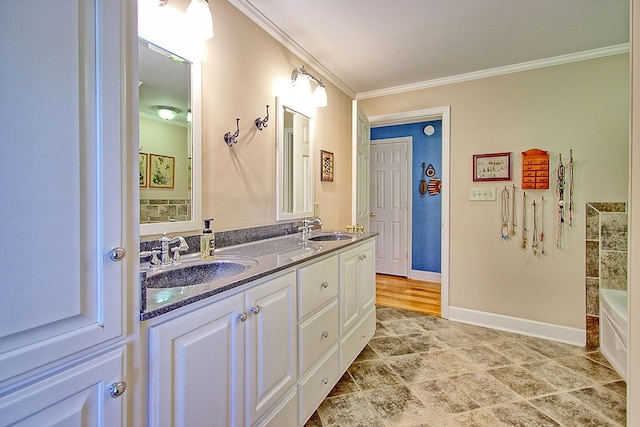 bathroom featuring vanity, crown molding, and a bathing tub