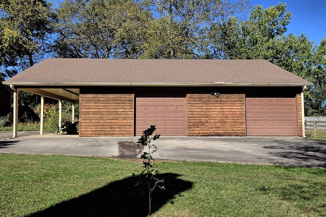 garage with a lawn and a carport