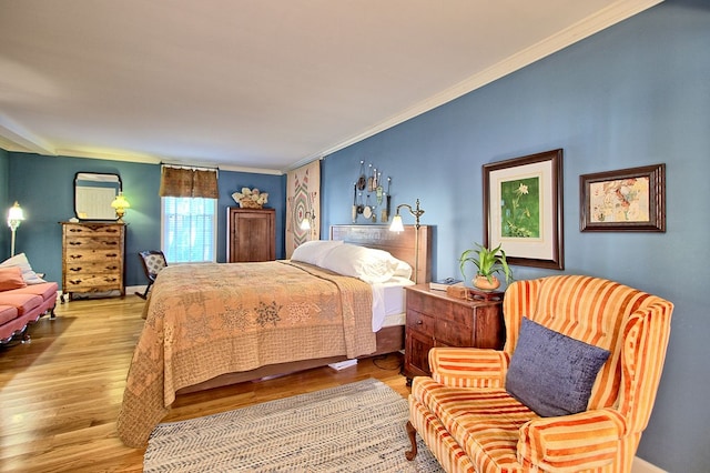 bedroom featuring light hardwood / wood-style flooring and ornamental molding