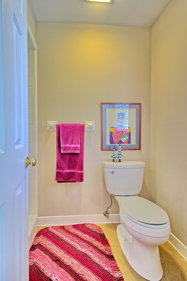 bathroom featuring toilet and tile patterned flooring