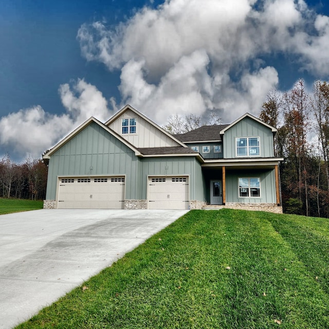 craftsman house featuring a front yard and a garage