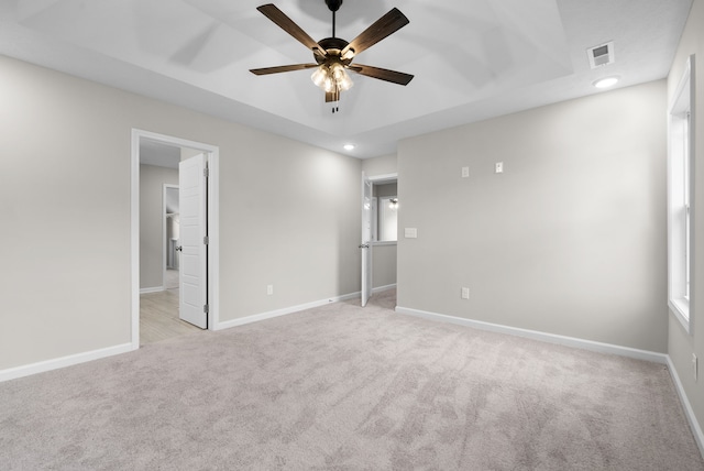 carpeted spare room featuring ceiling fan