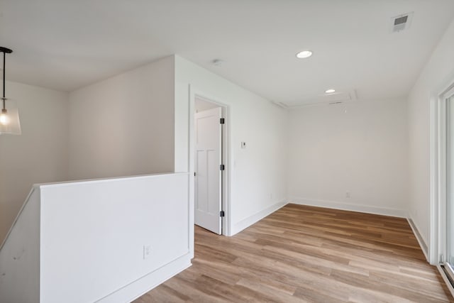 unfurnished room with light wood-type flooring