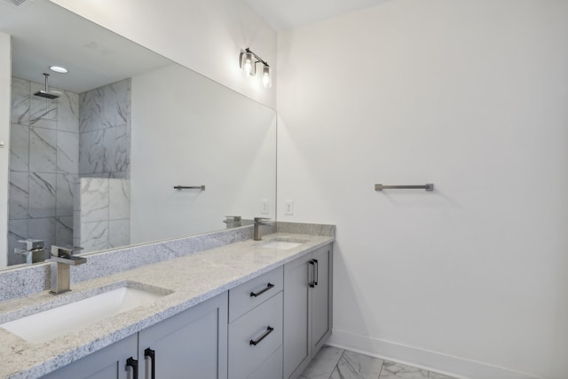 bathroom with vanity and a tile shower