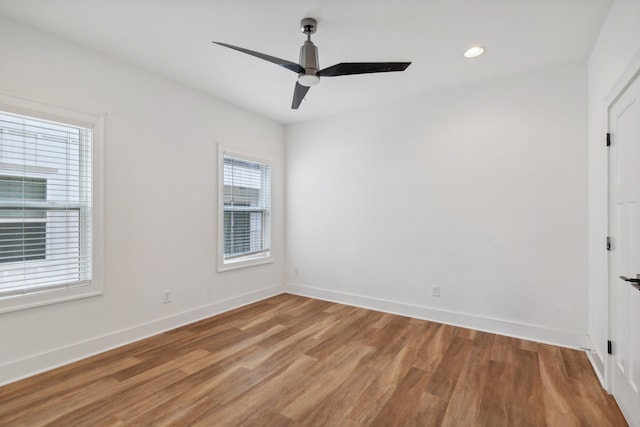 empty room featuring ceiling fan and hardwood / wood-style flooring