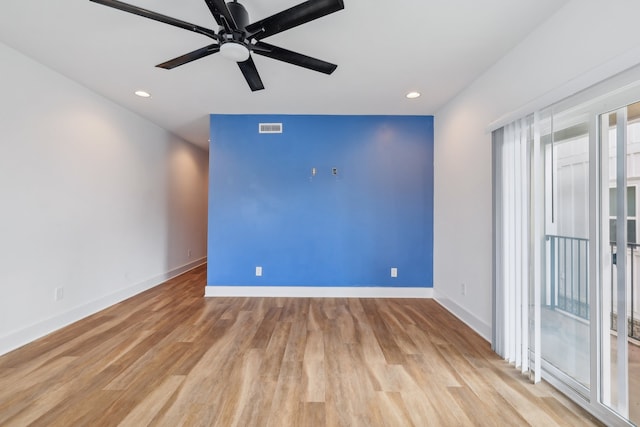 empty room featuring light wood-type flooring and ceiling fan