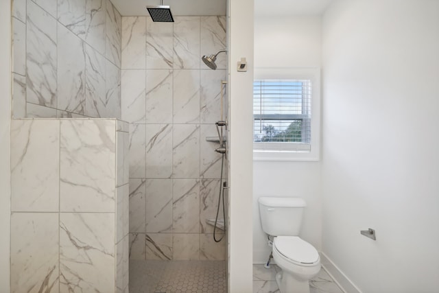 bathroom with toilet and tiled shower