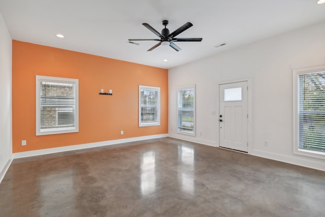 entryway with concrete floors, a healthy amount of sunlight, and ceiling fan