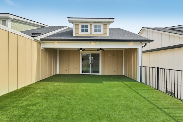 back of house with a lawn