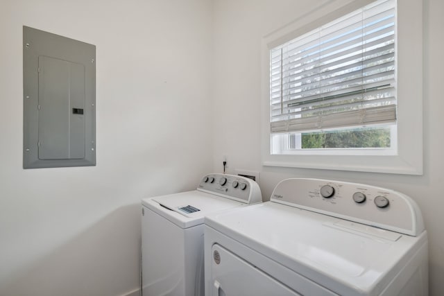 laundry area featuring separate washer and dryer, electric panel, and a wealth of natural light