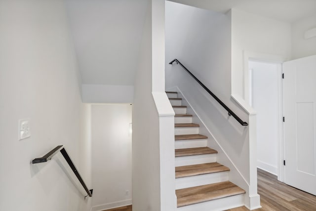 stairs featuring hardwood / wood-style flooring