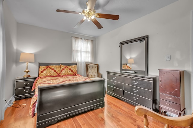 bedroom with hardwood / wood-style floors and ceiling fan