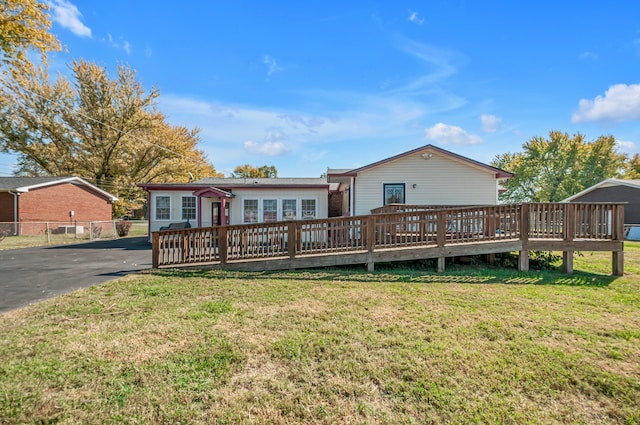 view of front of house featuring a front yard and a deck