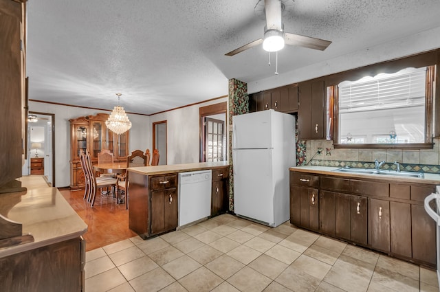 kitchen featuring decorative backsplash, dark brown cabinets, decorative light fixtures, and white appliances