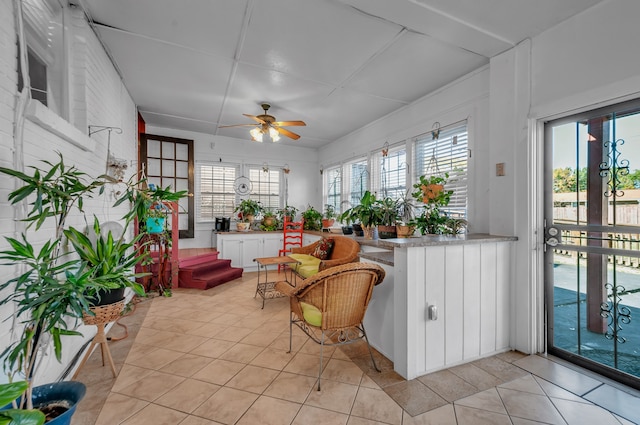 sunroom / solarium featuring ceiling fan