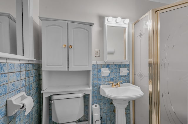 bathroom featuring tile walls and toilet