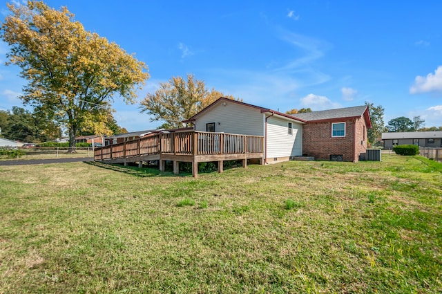 back of property featuring a yard, central AC, and a wooden deck