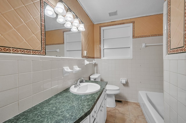 full bathroom featuring toilet, vanity, tile patterned floors, and tile walls