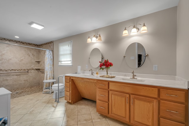 bathroom featuring toilet, vanity, a shower with shower curtain, and tile patterned flooring