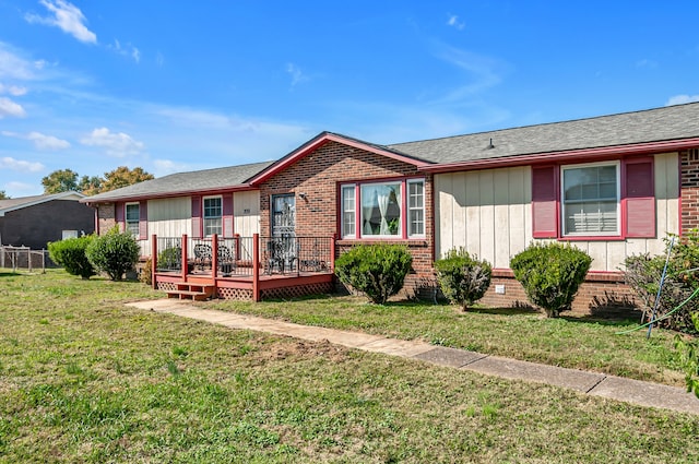 ranch-style home with a front lawn and a wooden deck