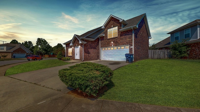 view of front facade with a lawn and a garage