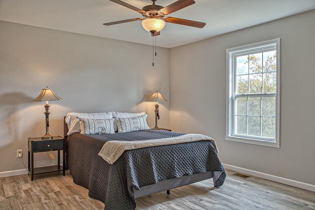 10309 Goff Ridge Rd, Baxter, TN 38544 - bedroom featuring multiple windows, baseboards, wood finished floors, and a ceiling fan