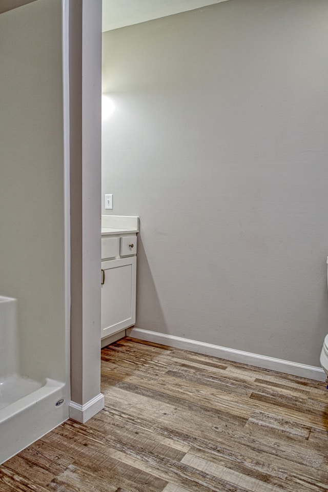 bathroom with vanity, hardwood / wood-style flooring, and toilet