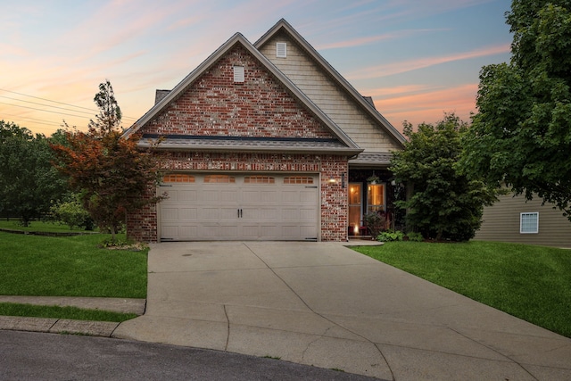 craftsman-style home featuring a garage and a lawn