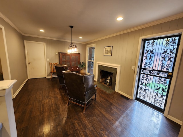 living room featuring a tile fireplace, dark hardwood / wood-style flooring, and ornamental molding