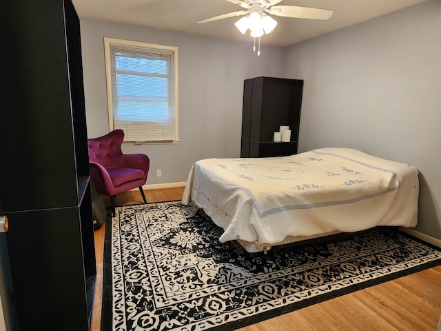 bedroom with wood-type flooring and ceiling fan