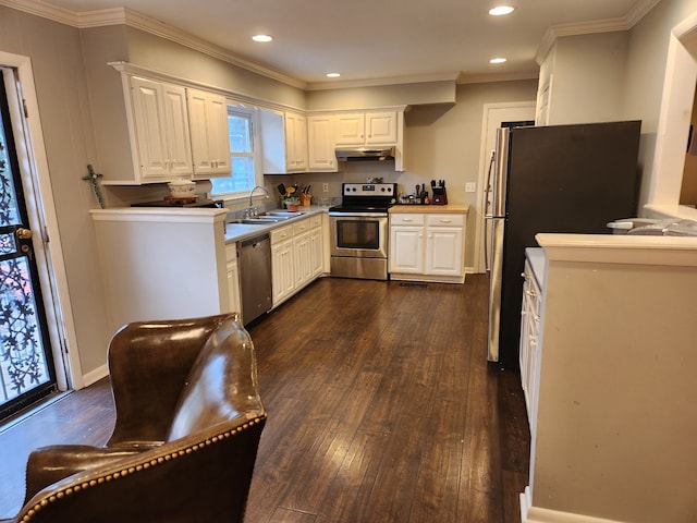 kitchen with dark wood-type flooring, sink, ornamental molding, white cabinetry, and appliances with stainless steel finishes