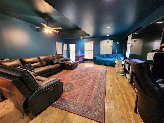 living room with ceiling fan and light hardwood / wood-style flooring