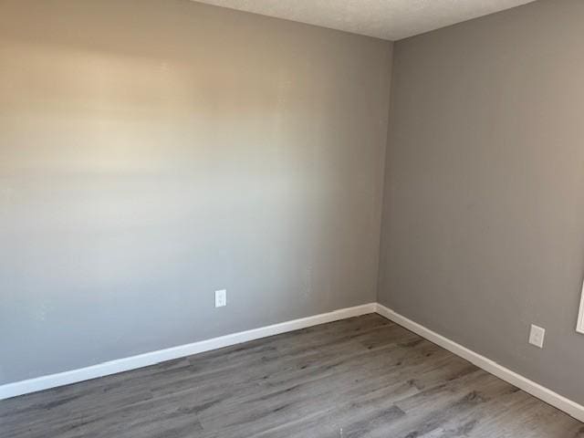 spare room with hardwood / wood-style floors