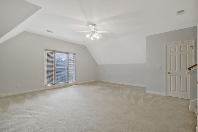 additional living space with ceiling fan, light colored carpet, and lofted ceiling