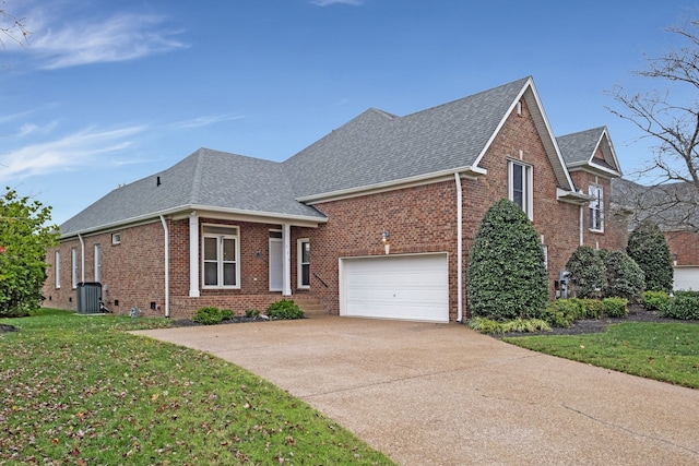 view of front facade featuring a front lawn, a garage, and cooling unit